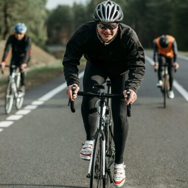 Group of cyclists racing on an open country road.