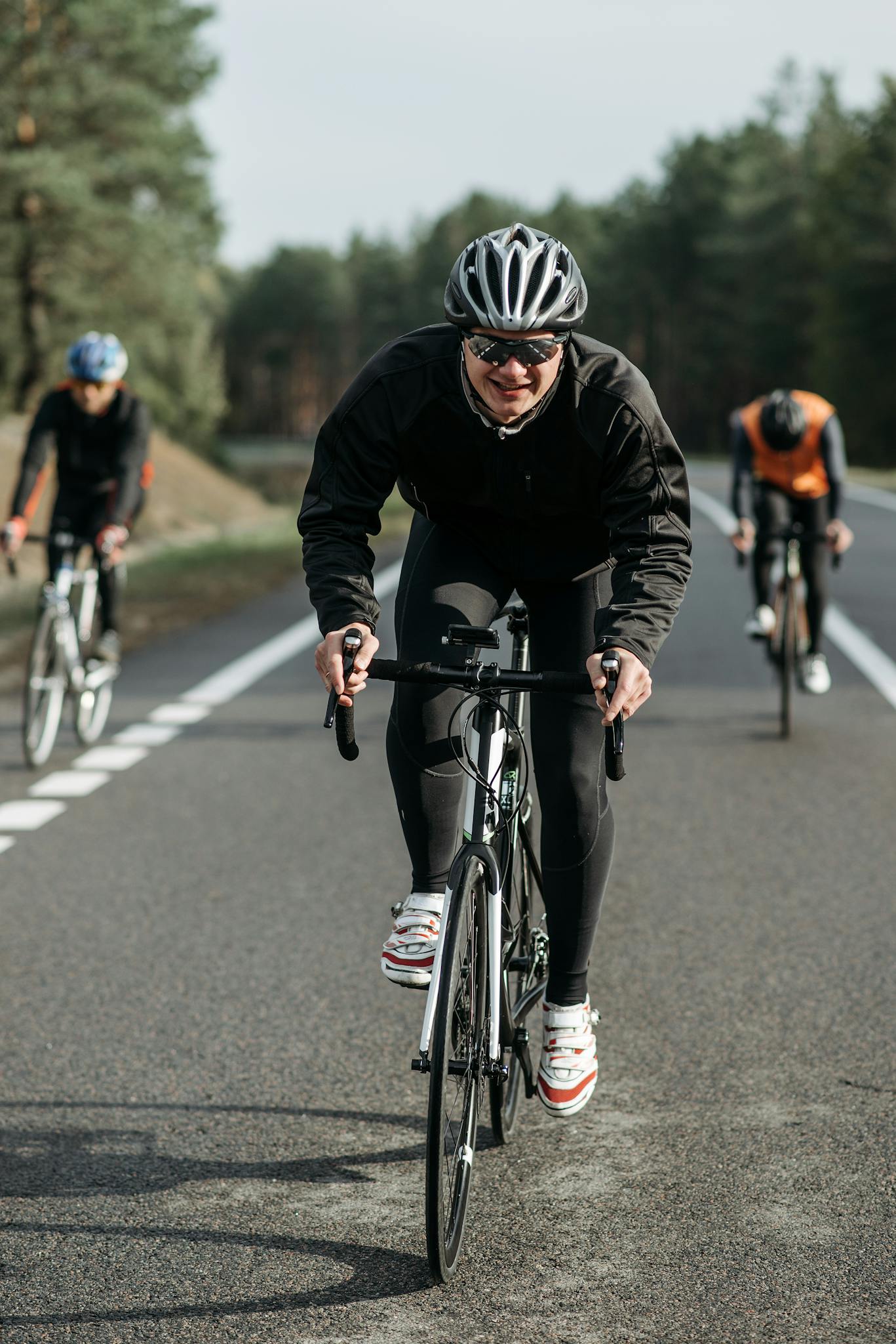 Group of cyclists racing on an open country road.